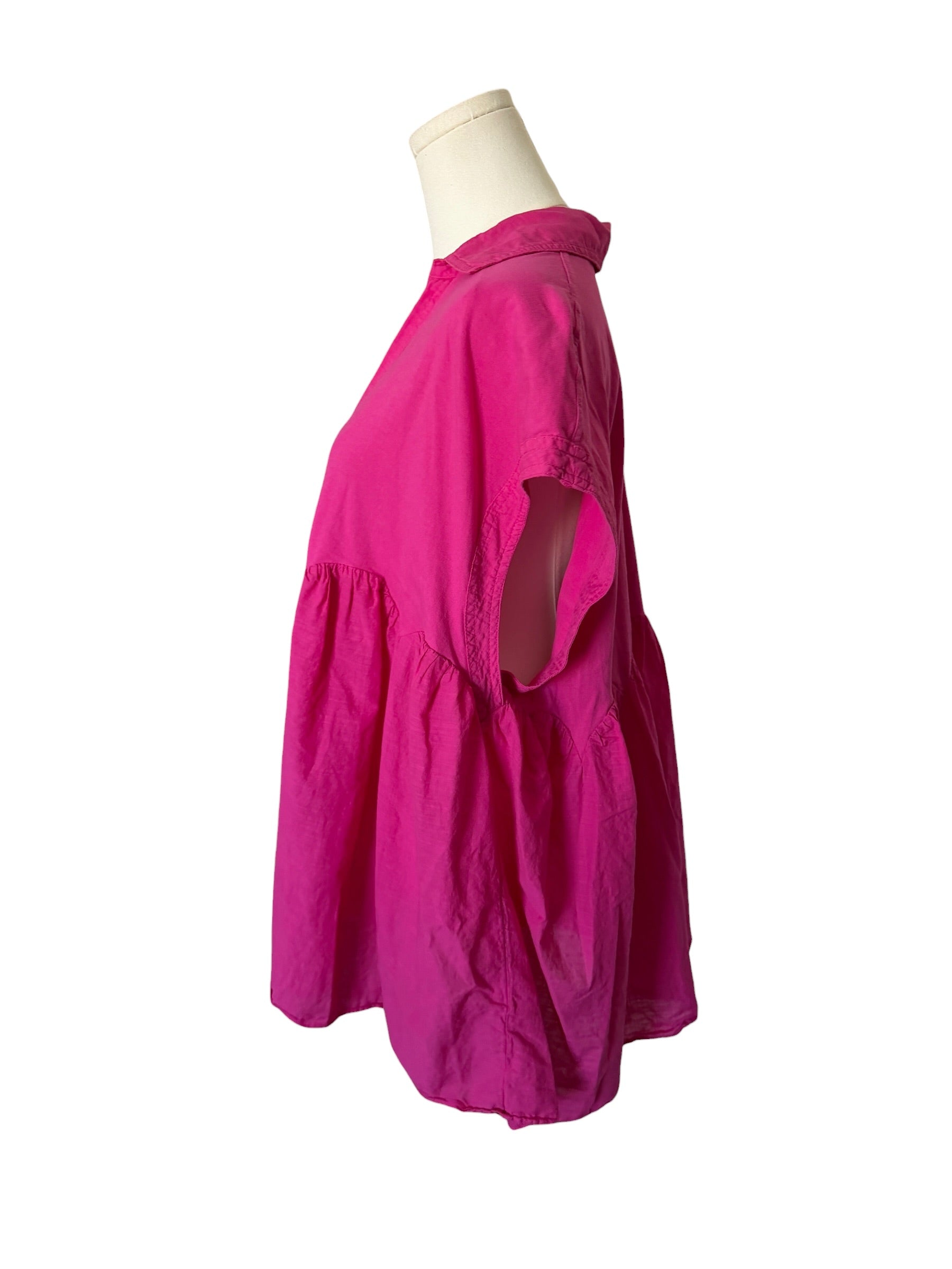 Pink dress on a mannequin against a white background