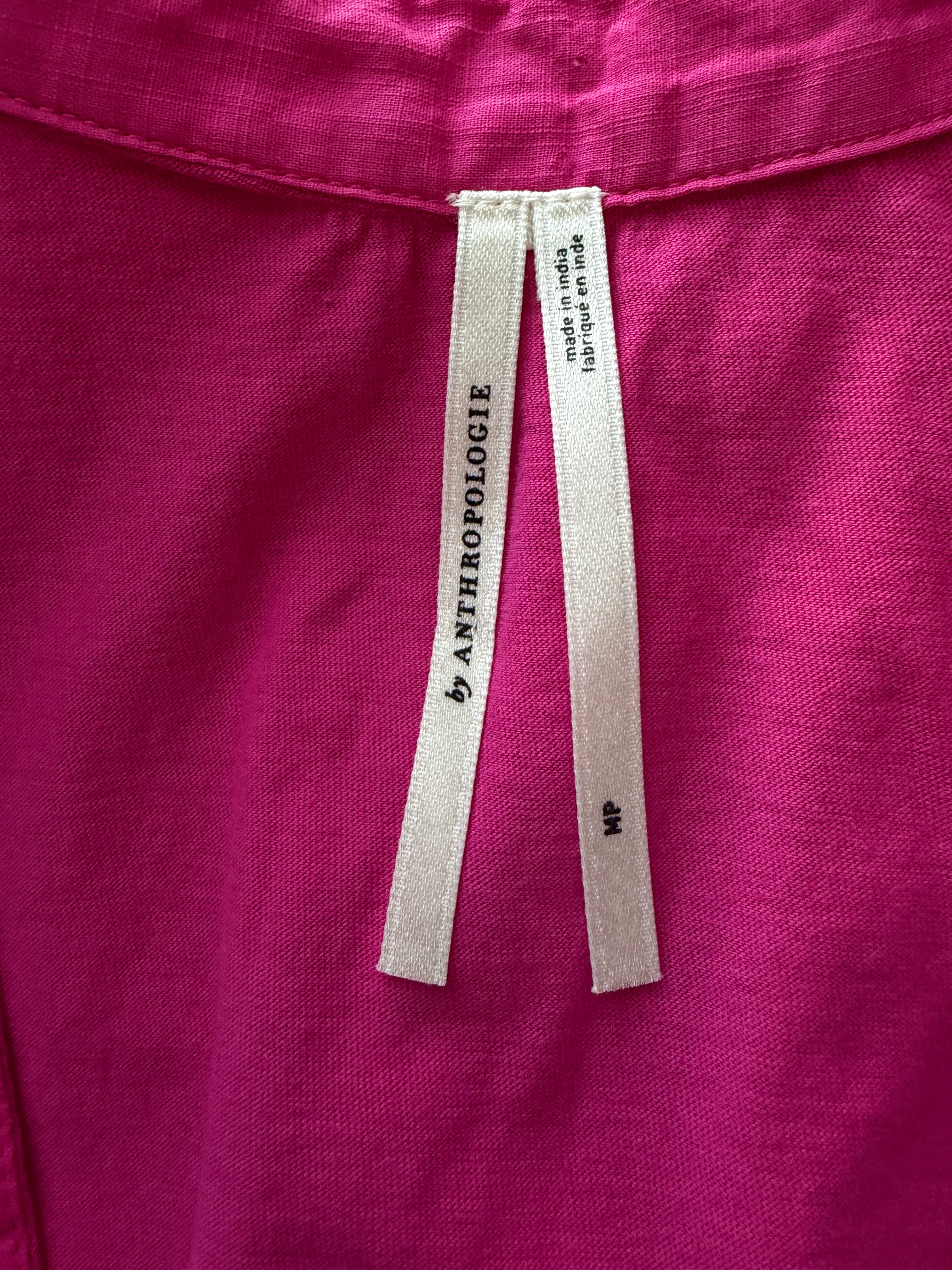Close-up of a pink garment with an Anthropologie label.