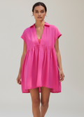 Woman wearing a bright pink dress on a white background