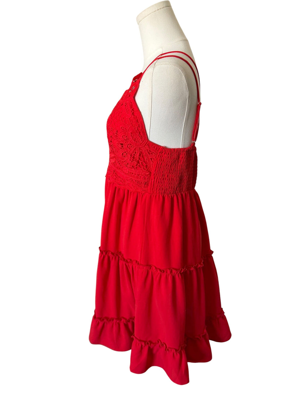 Red dress on a mannequin against a white background