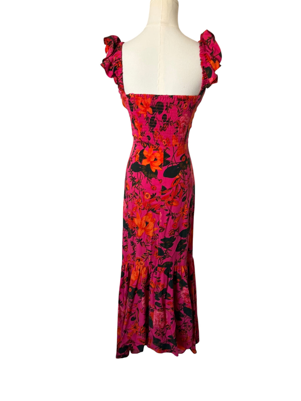 Floral dress on a mannequin against a white background