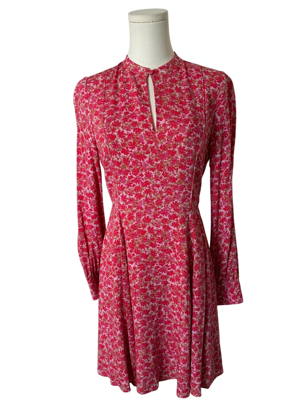 Red floral dress on a mannequin against a white background