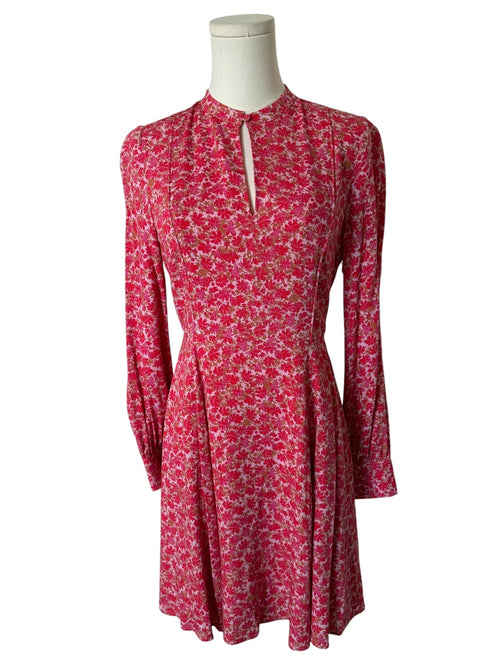 Red floral dress on a mannequin against a white background