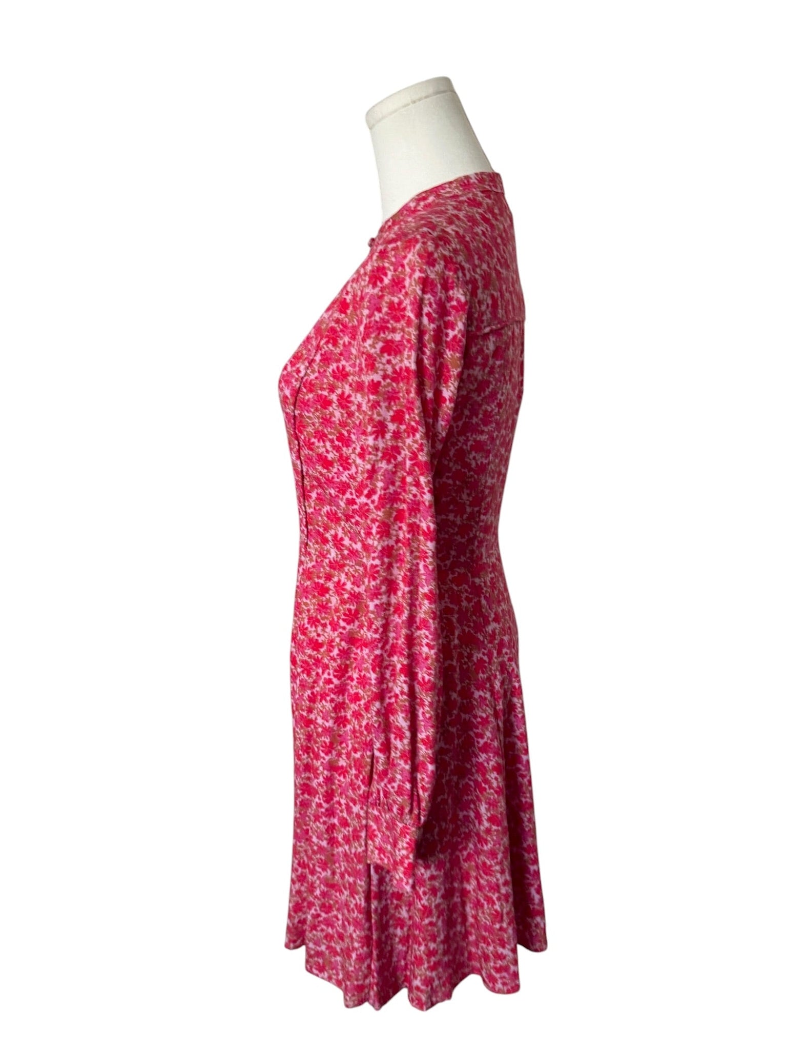 Red floral dress on a mannequin against a white background