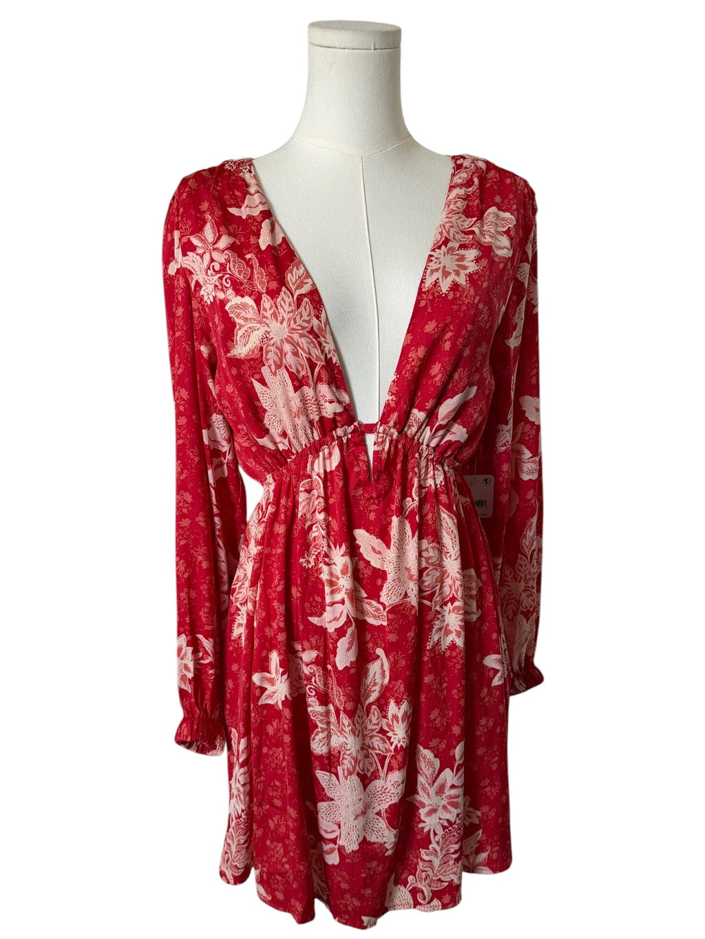 Red floral dress on a mannequin against a white background
