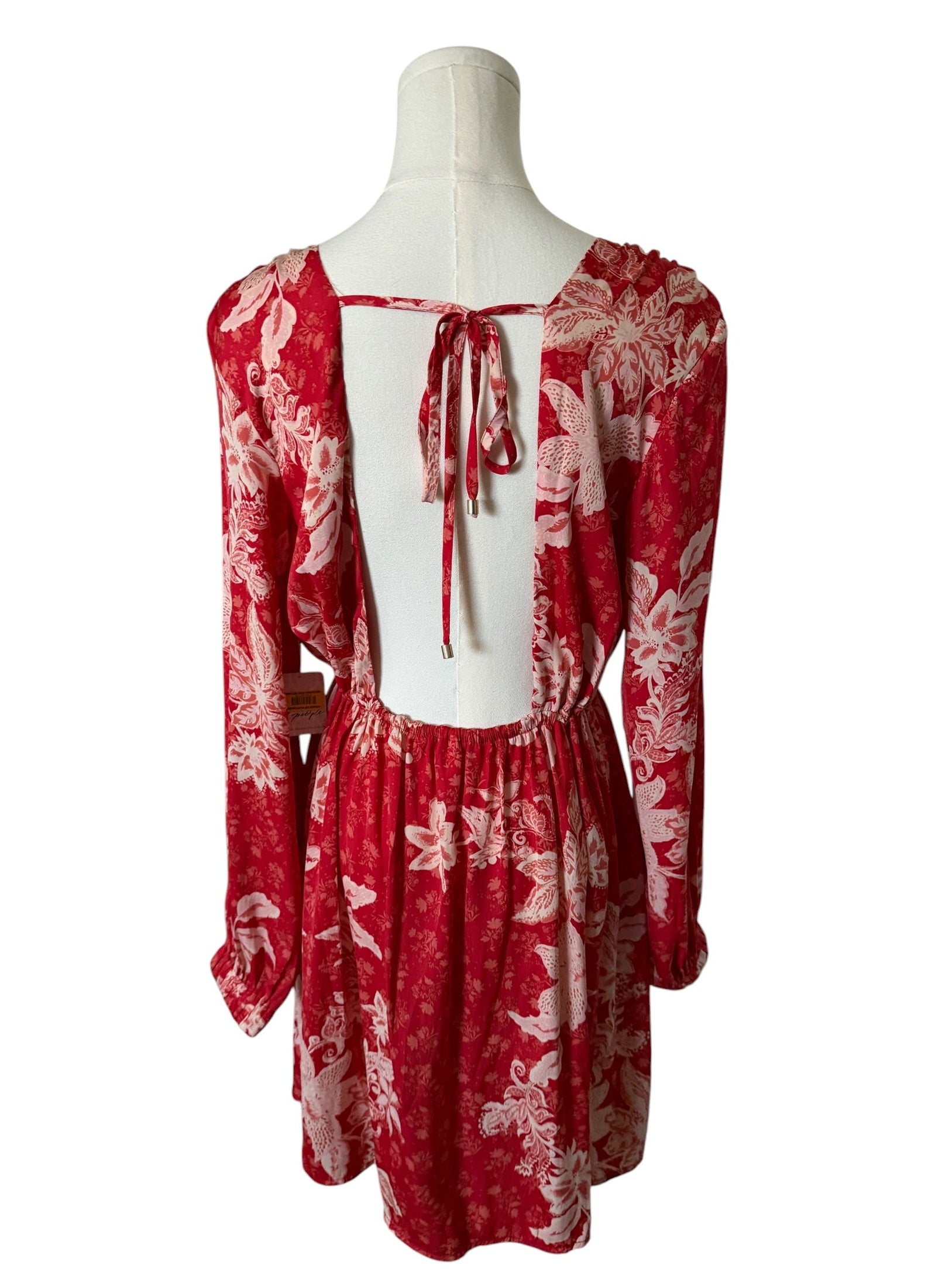 Red floral dress on a mannequin against a white background