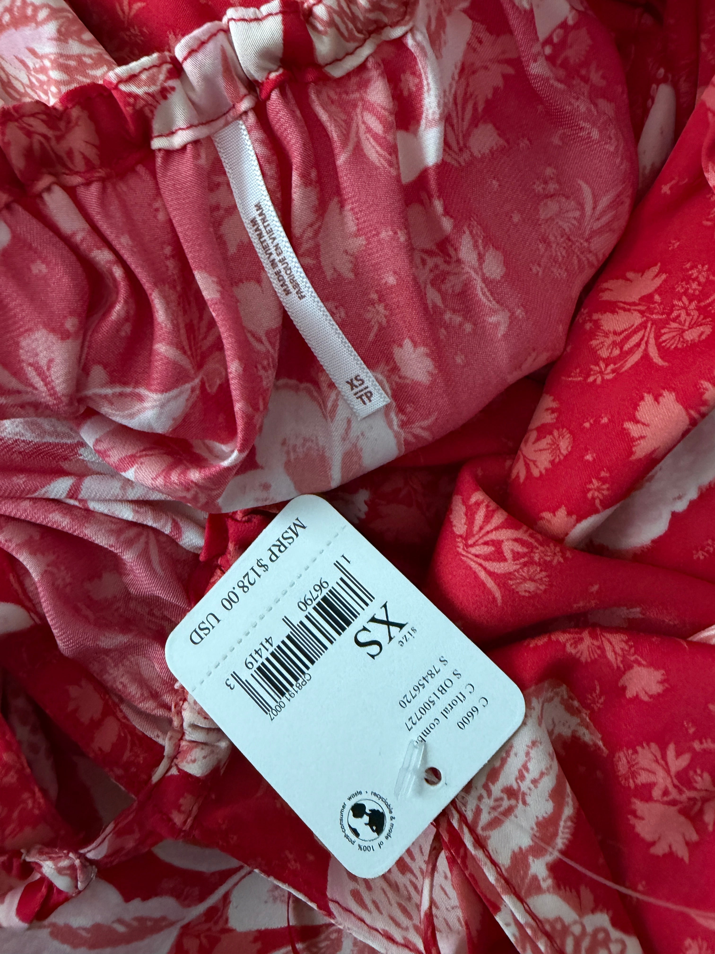 Red floral fabric with a size tag indicating 'XS' on a white background