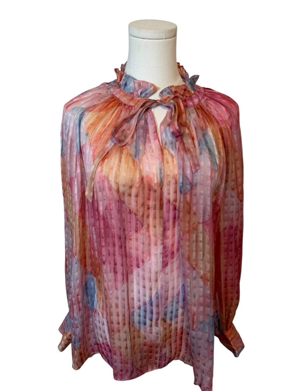 Colorful blouse on a mannequin against a white background