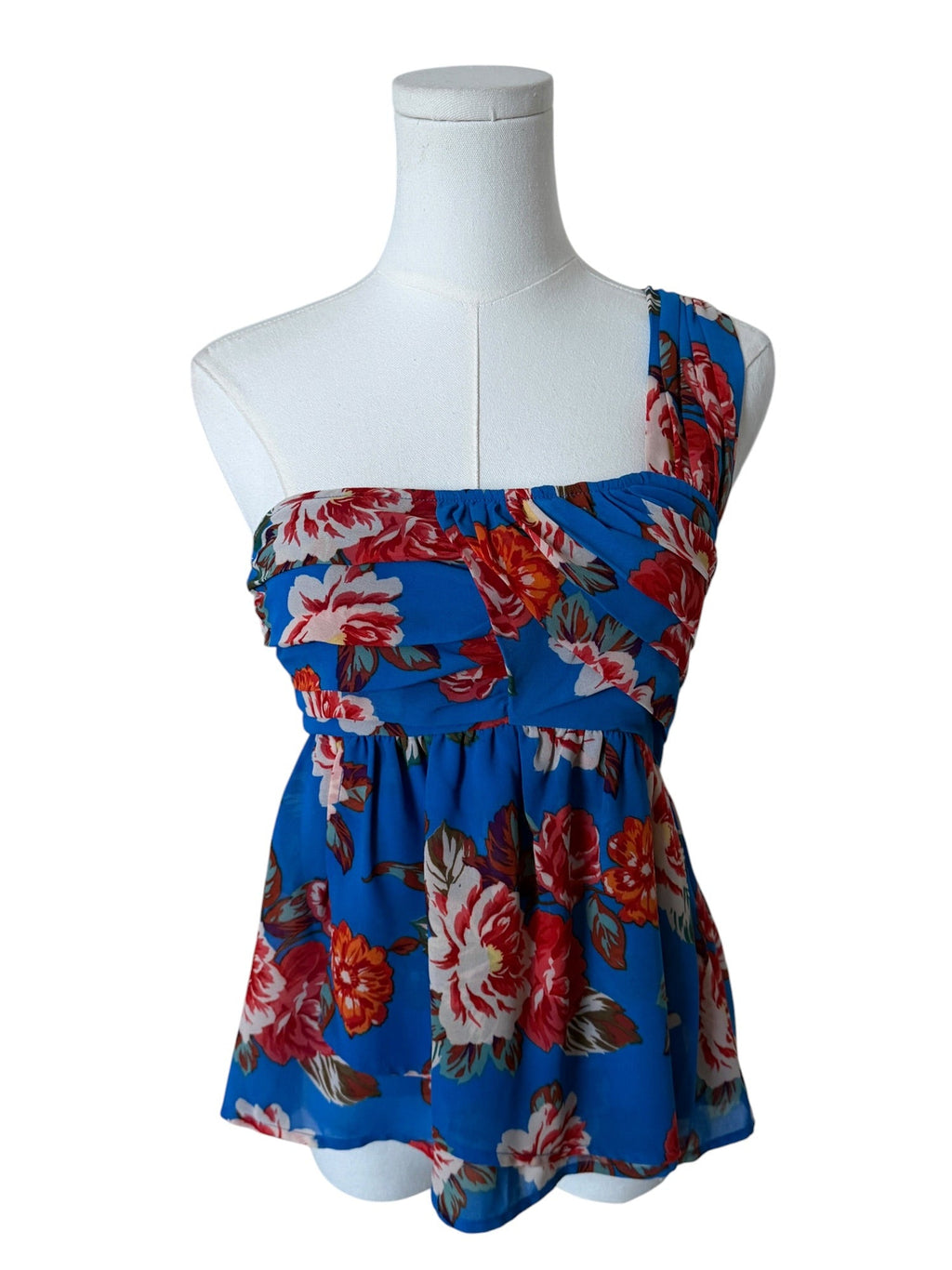 Floral dress on a mannequin against a white background