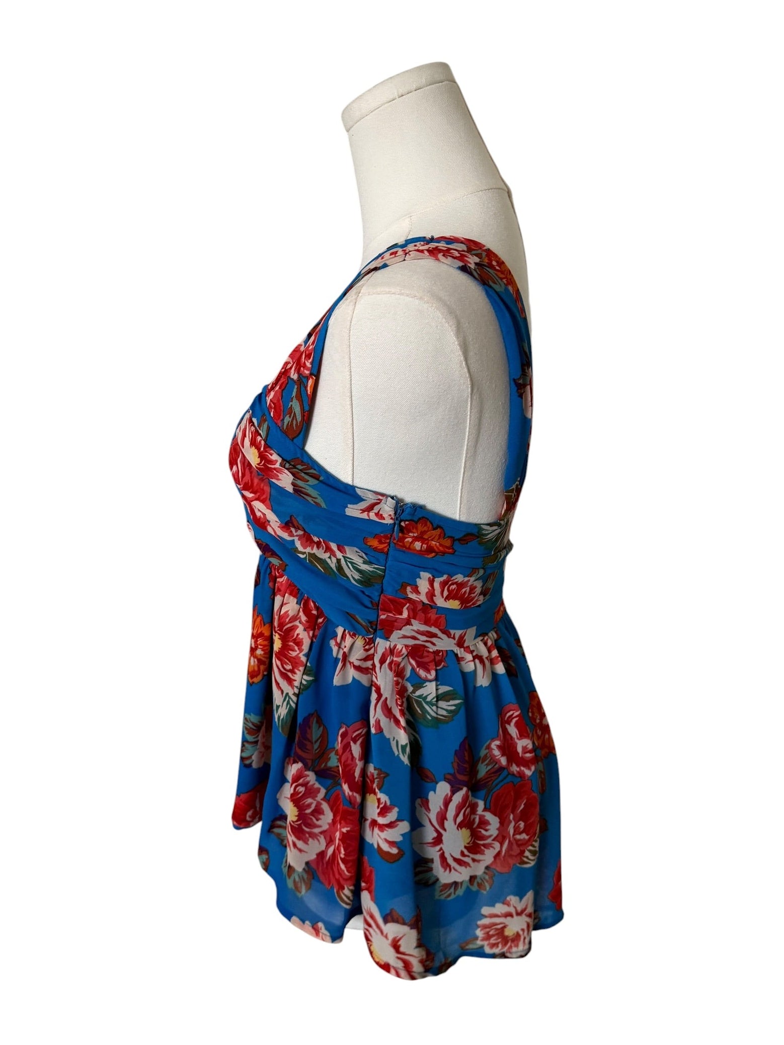 Blue floral dress on a mannequin against a white background