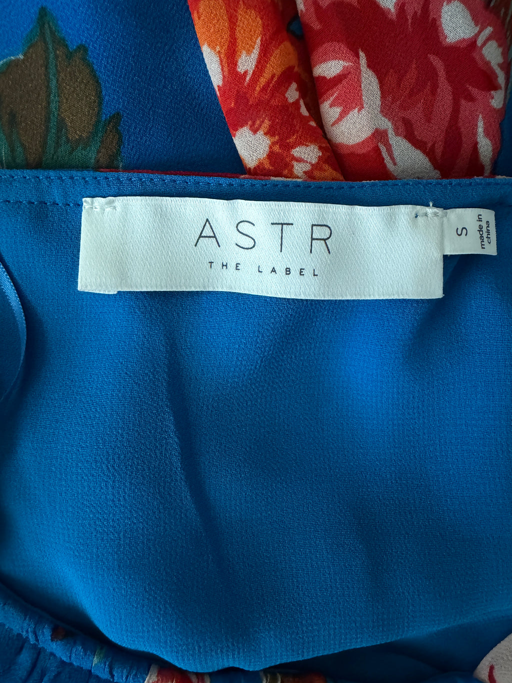 Blue fabric with 'Astr The Label' tag on a colorful background