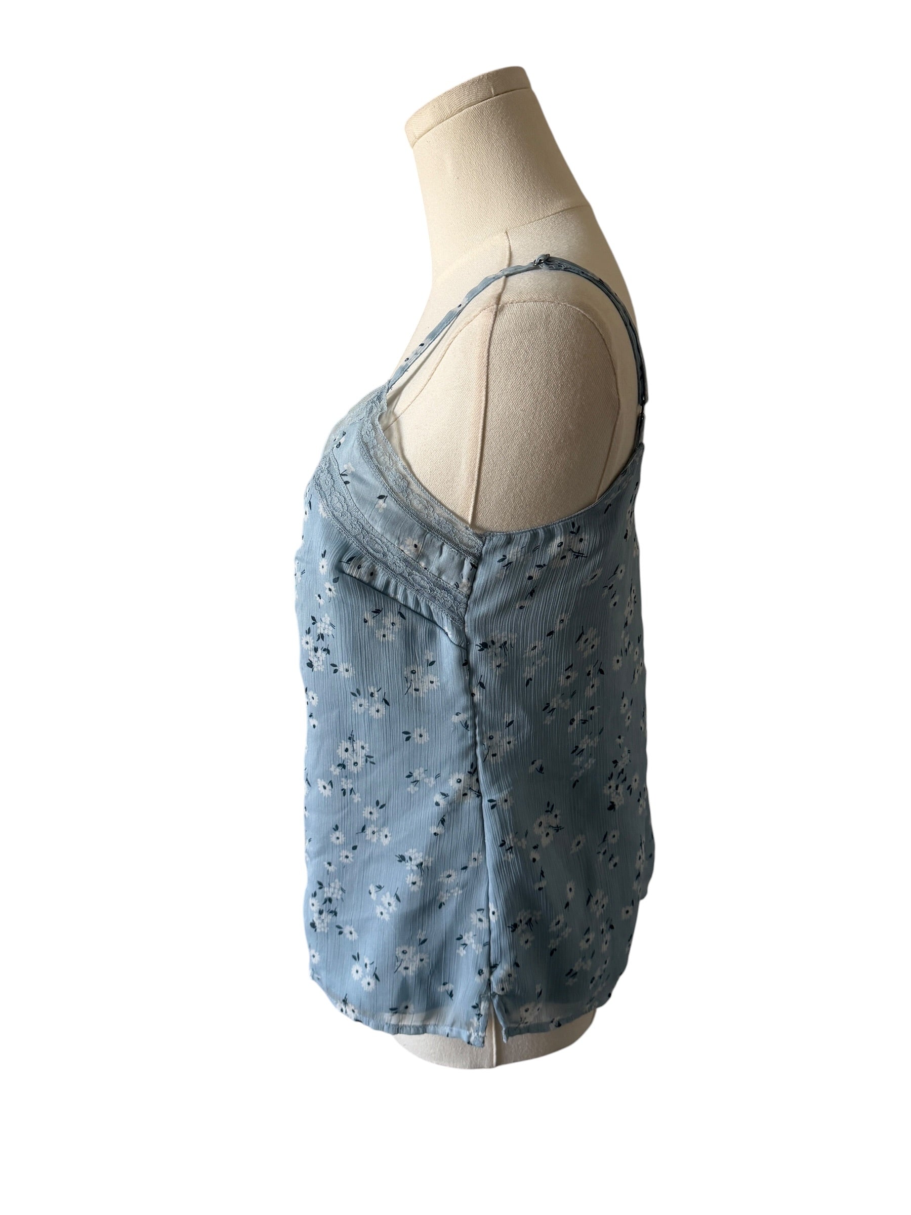 Light blue denim dress with floral patterns on a mannequin against a white background