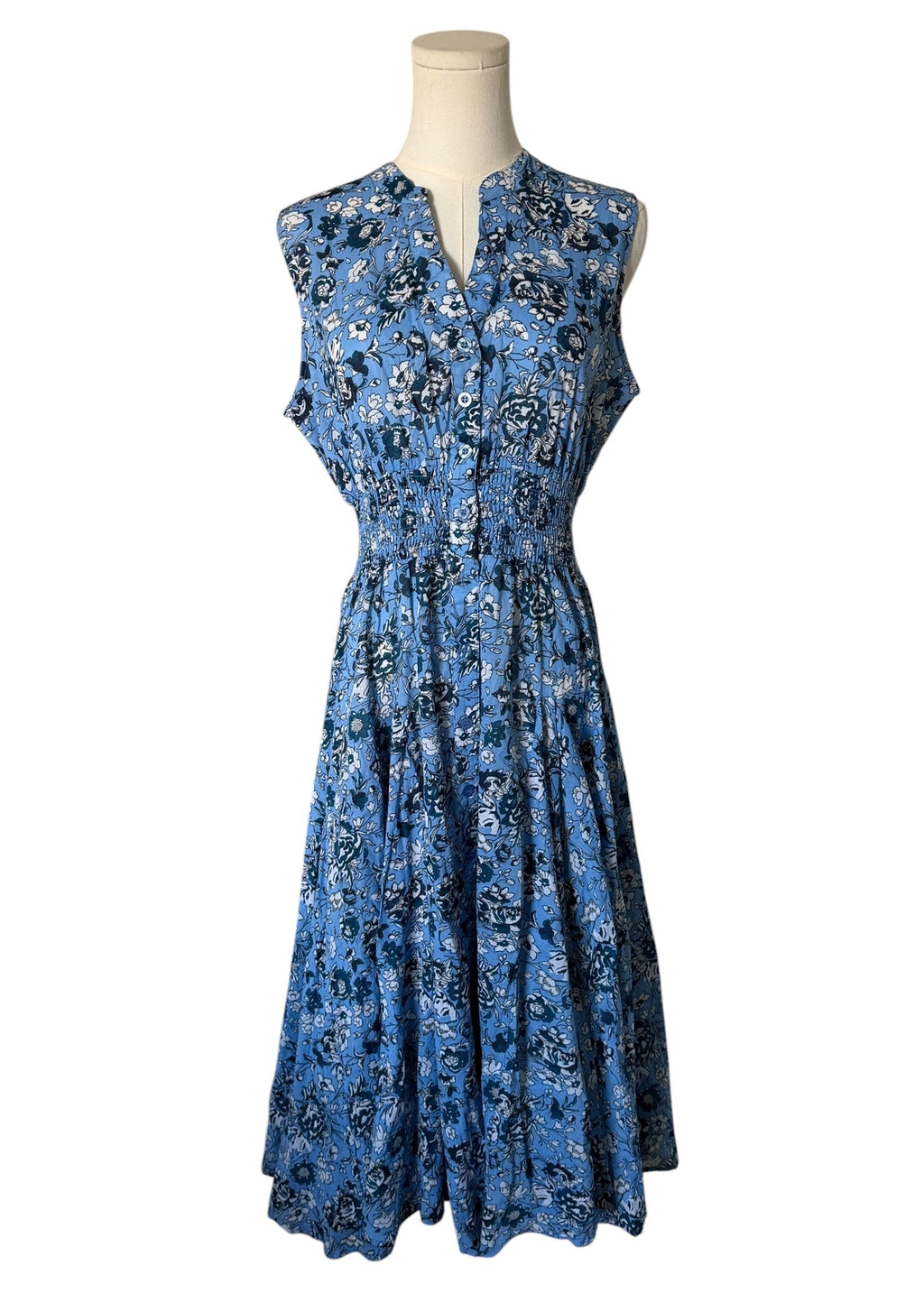 Blue floral dress on a mannequin against a white background