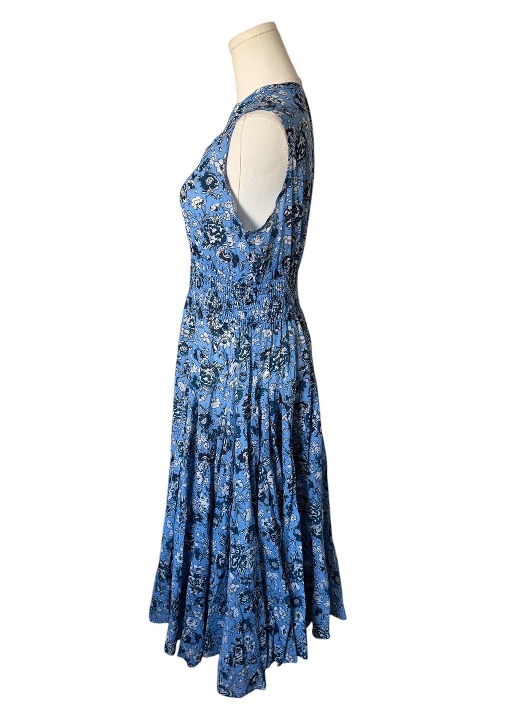 Blue floral dress on a mannequin against a white background