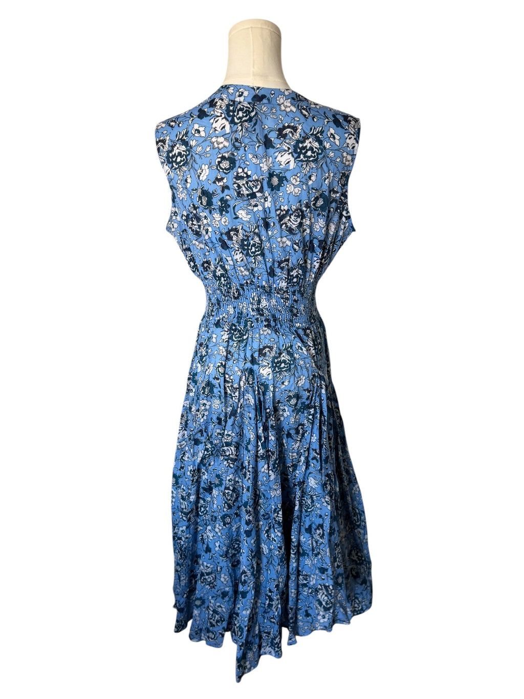 Blue floral dress on a mannequin against a white background