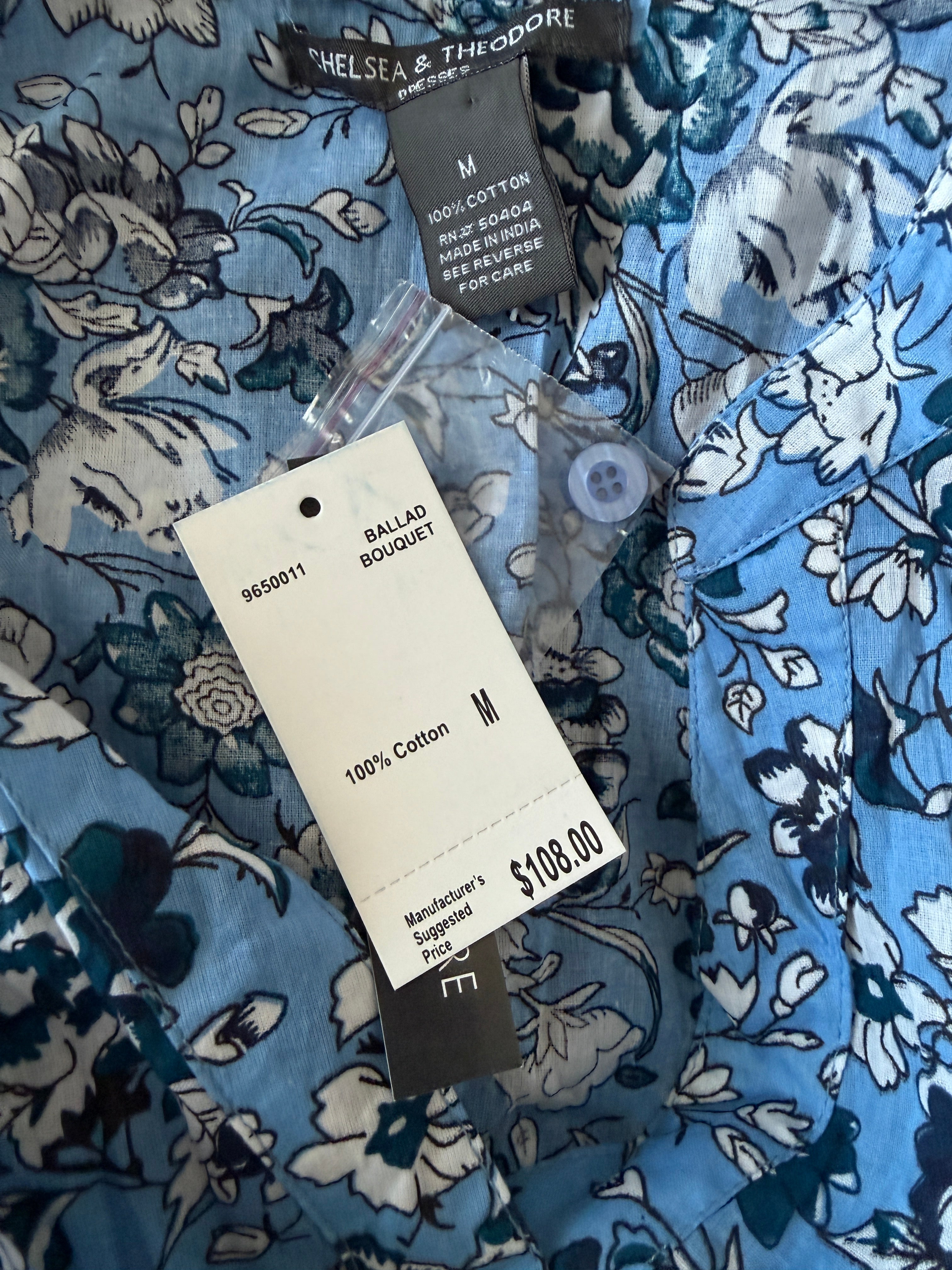 Clothing tag on a blue floral-patterned fabric