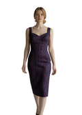 Woman wearing a fitted purple dress against a plain background