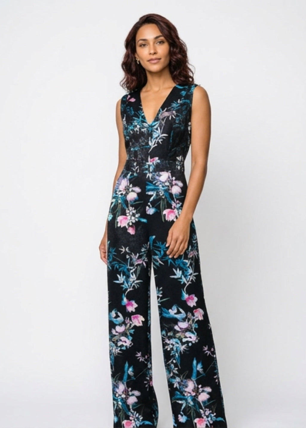 Woman wearing a black floral jumpsuit on a white background
