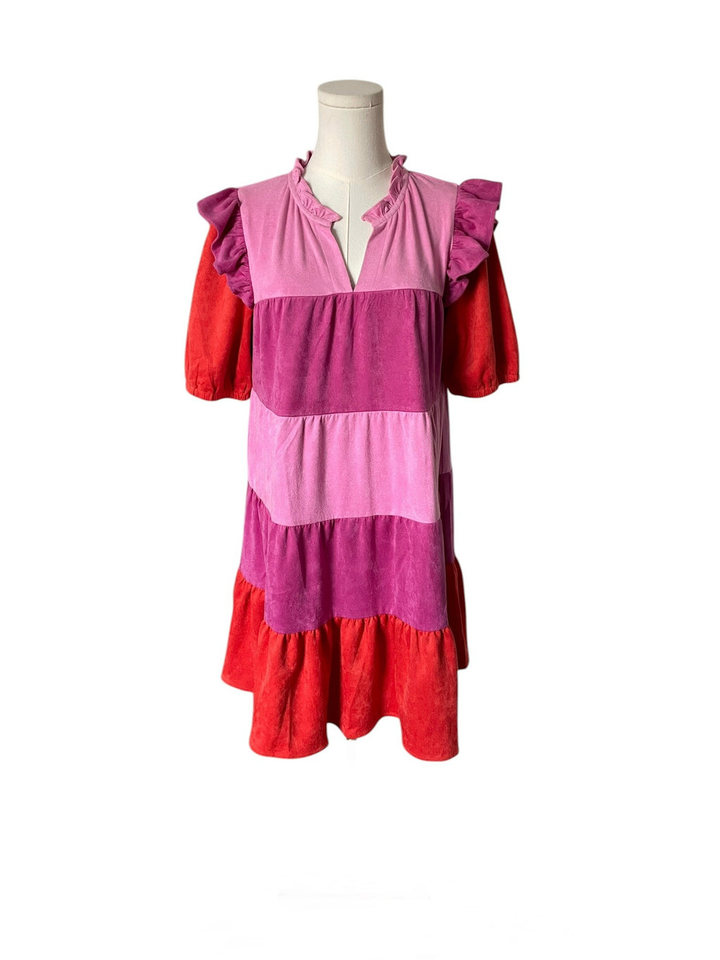 Mannequin wearing a dress with pink and red striped pattern on a white background