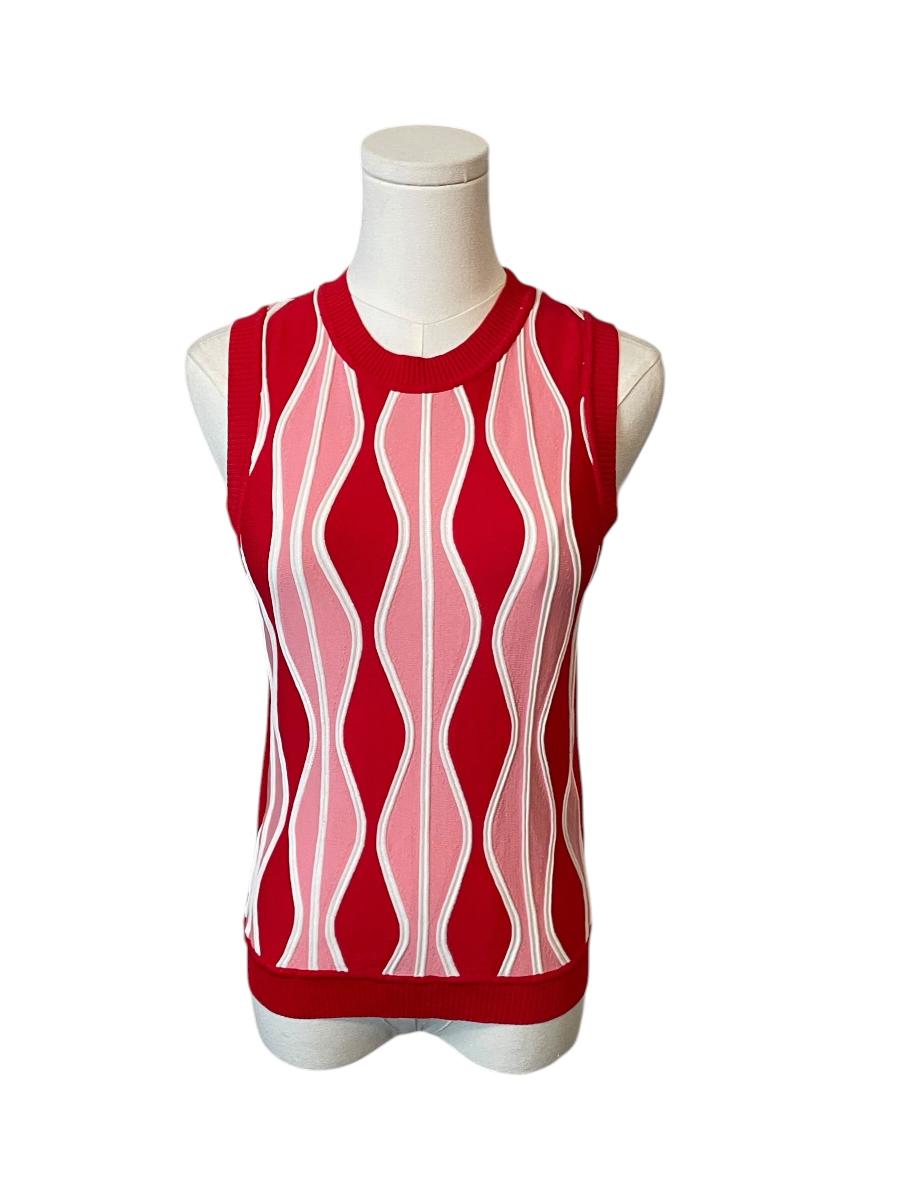 Red sleeveless top with pink and white pattern on a mannequin against a white background