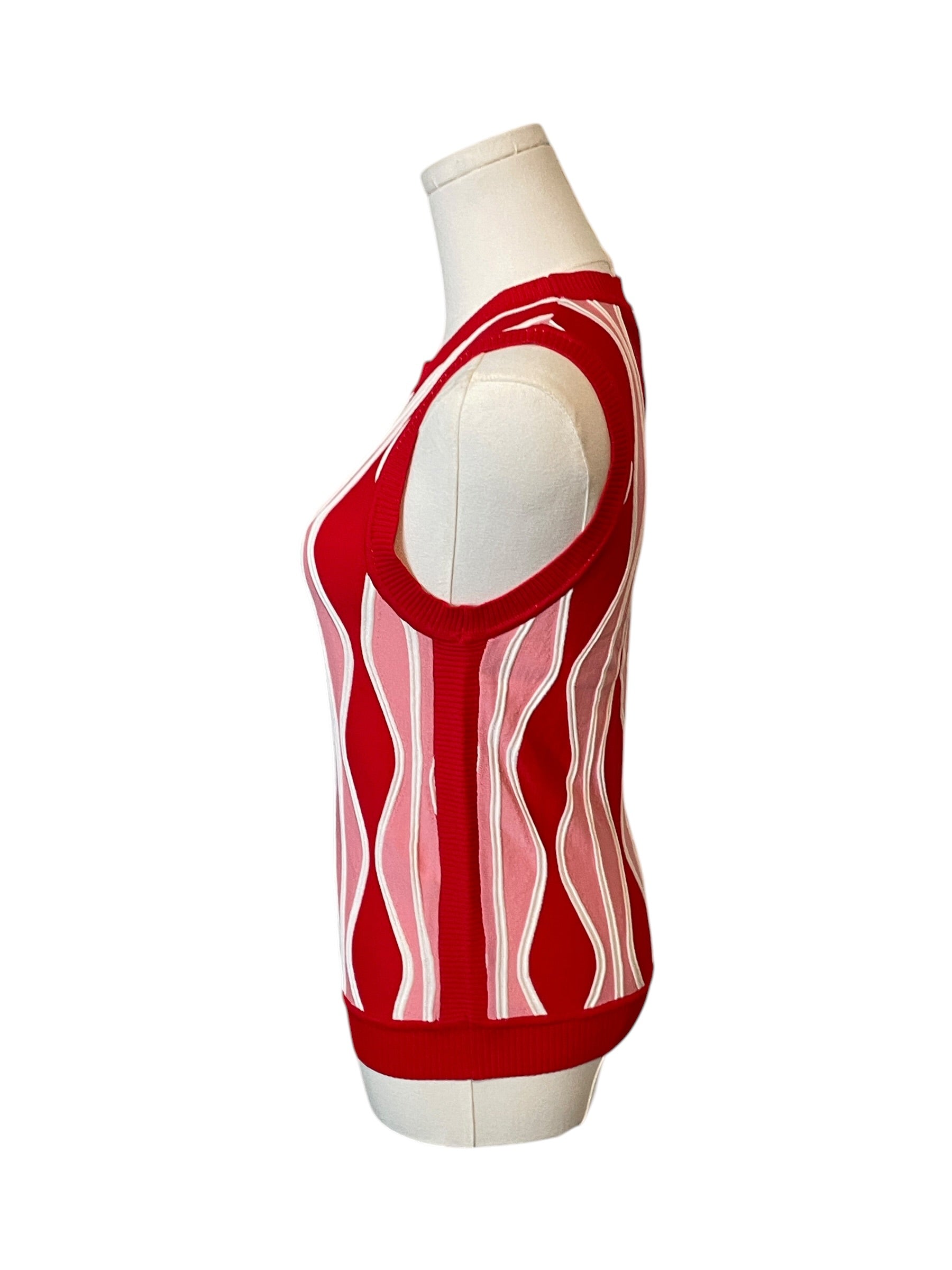 Red and white sleeveless top on a mannequin against a white background