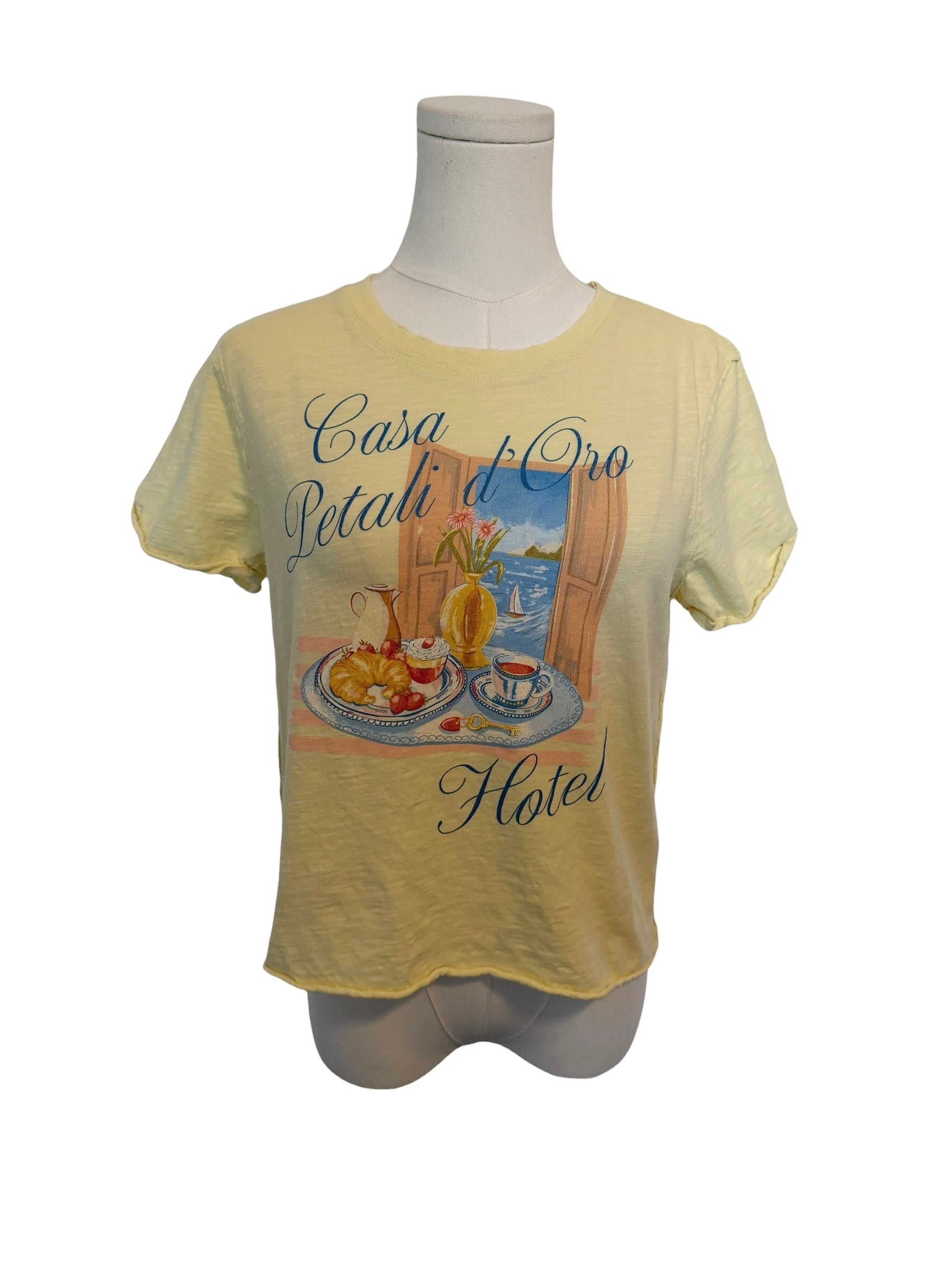 Yellow t-shirt with a graphic design on a mannequin against a white background