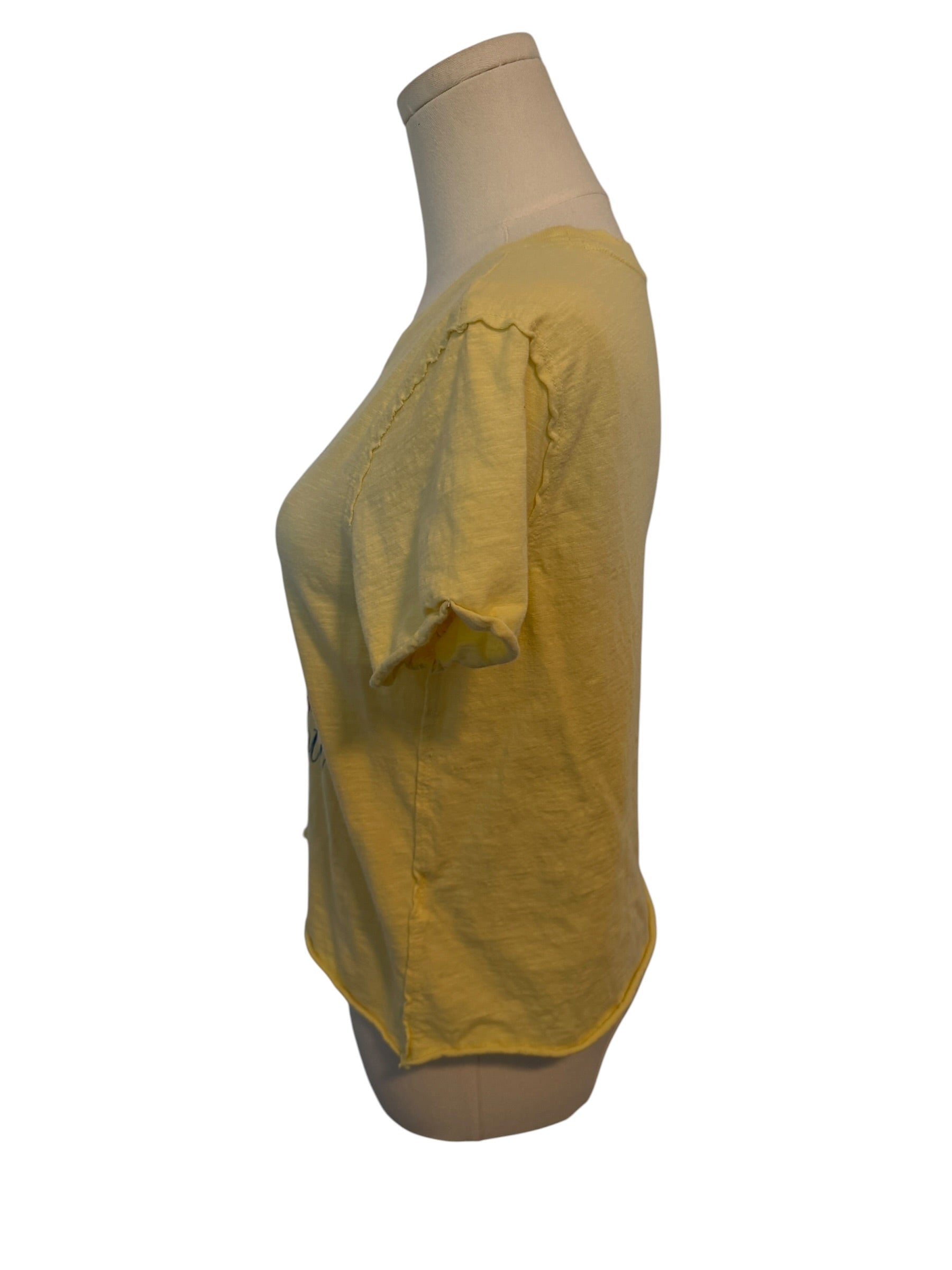 Yellow blouse on a mannequin against a white background
