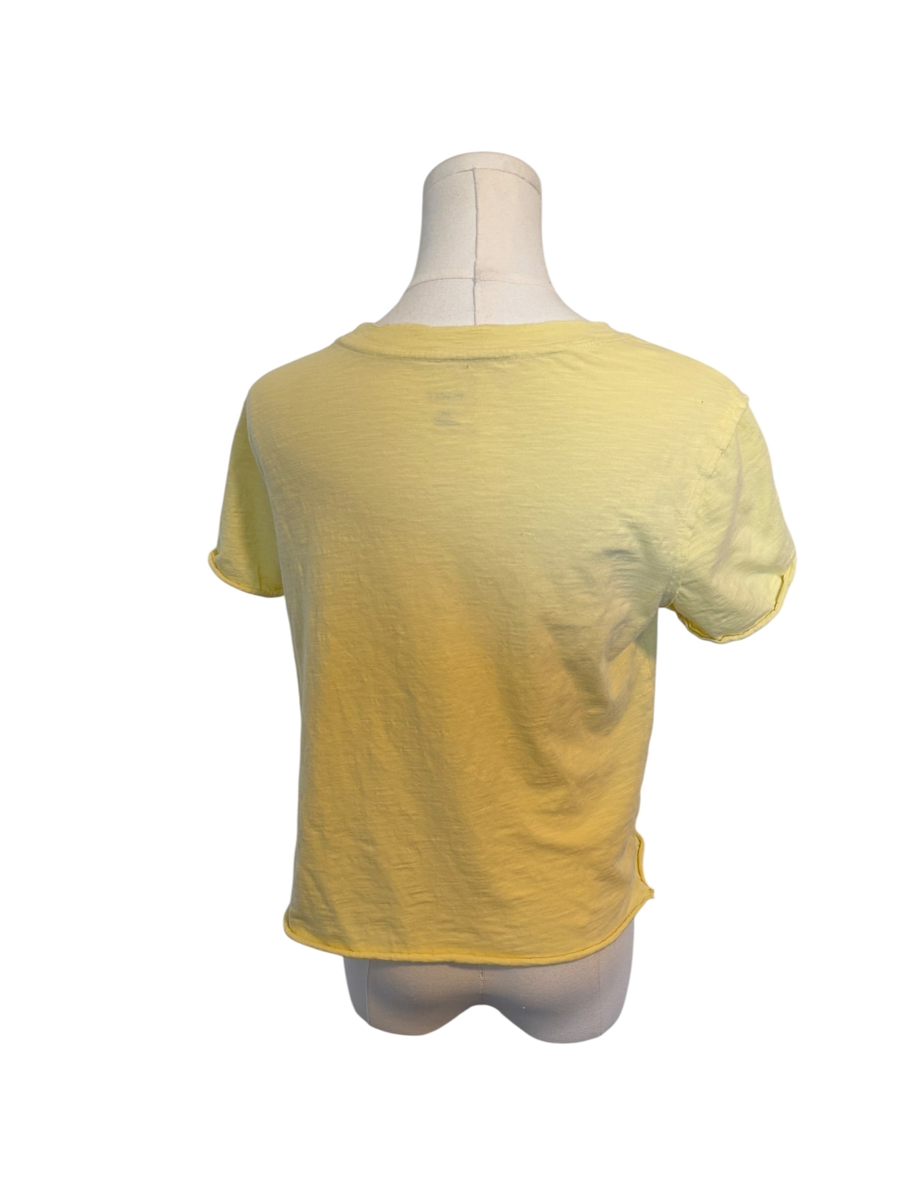 Yellow t-shirt on a mannequin against a white background