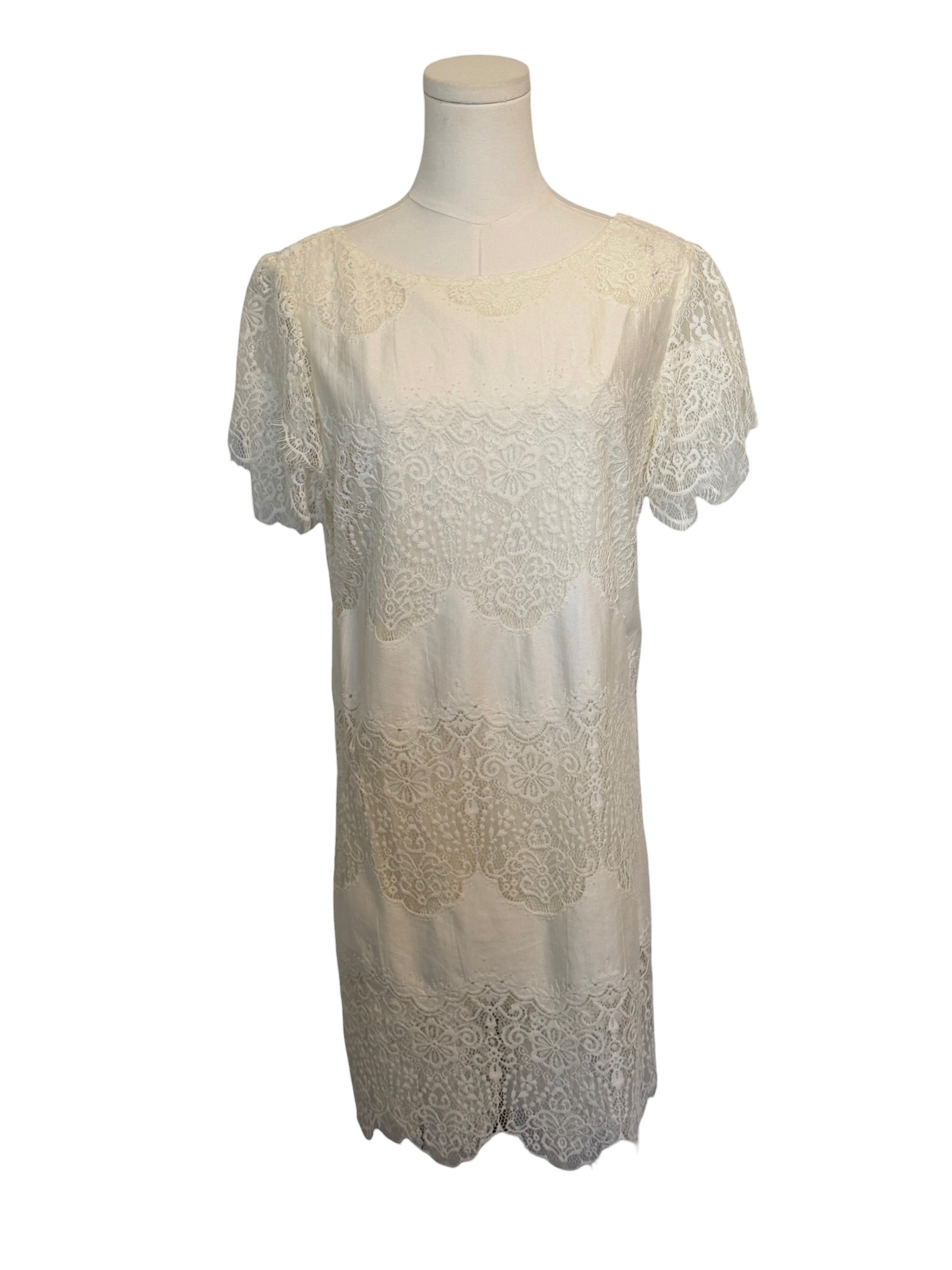 White lace dress on a mannequin against a white background
