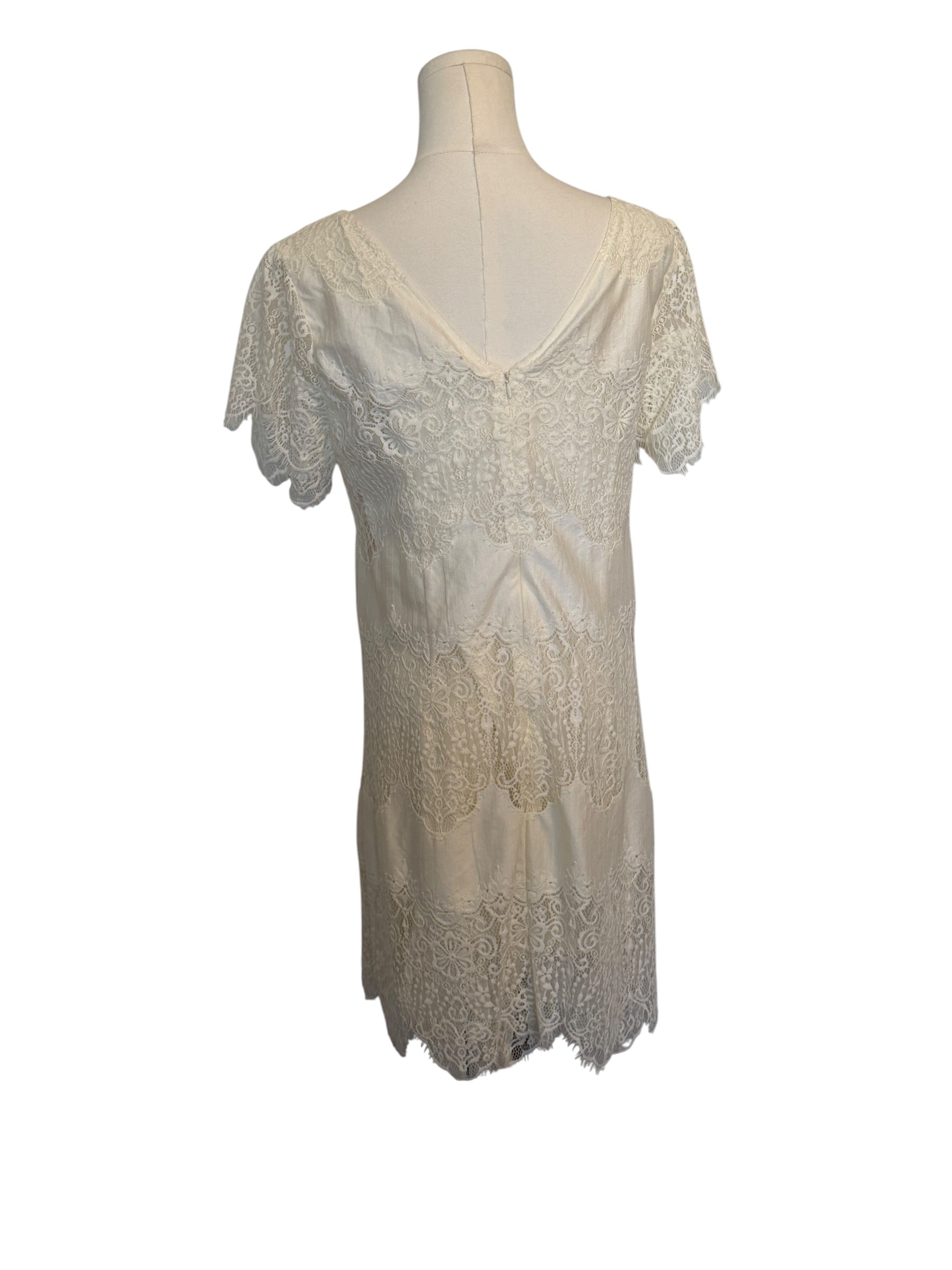 White lace dress on a mannequin against a white background