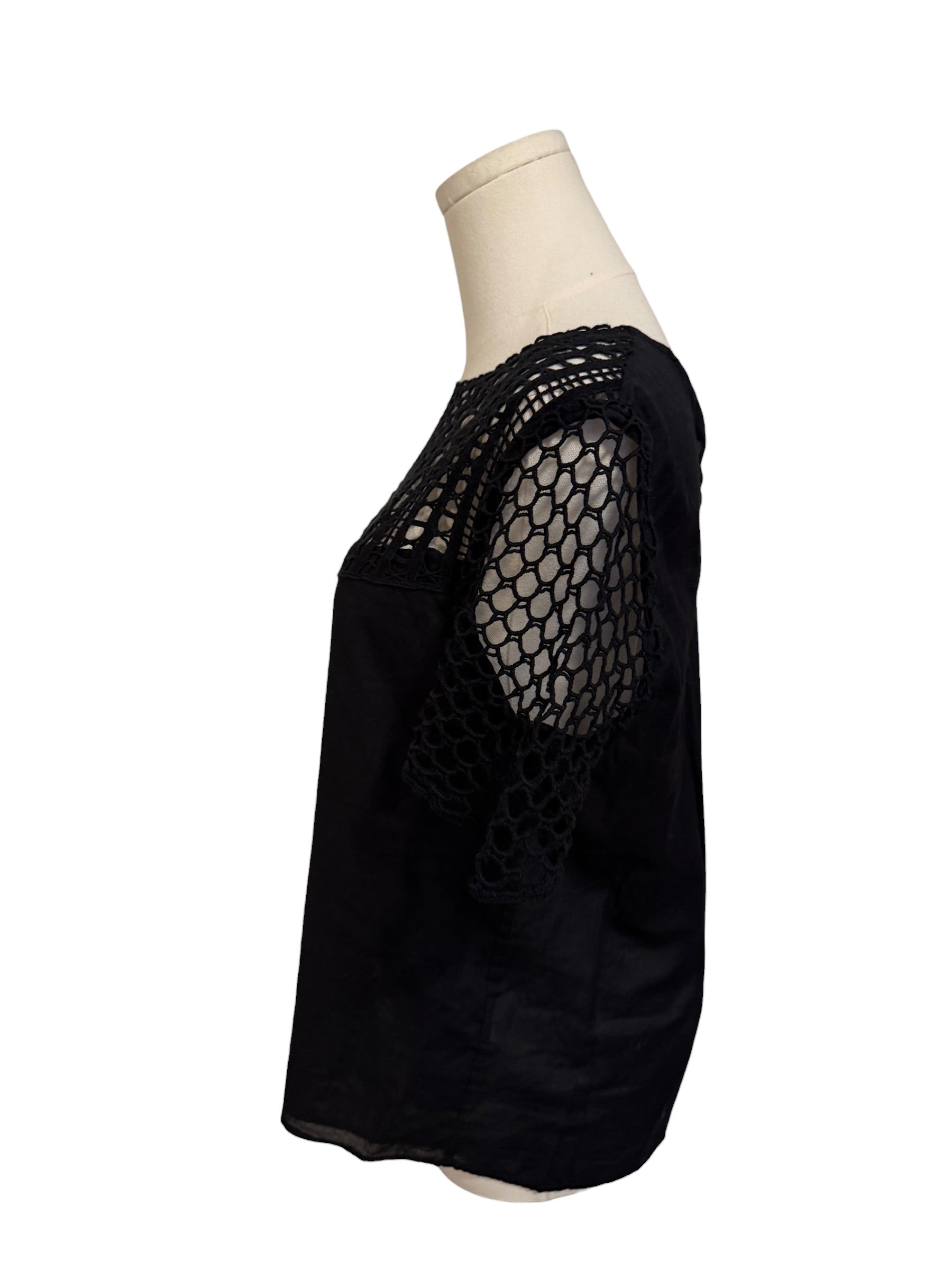 Black mesh top on a mannequin against a white background