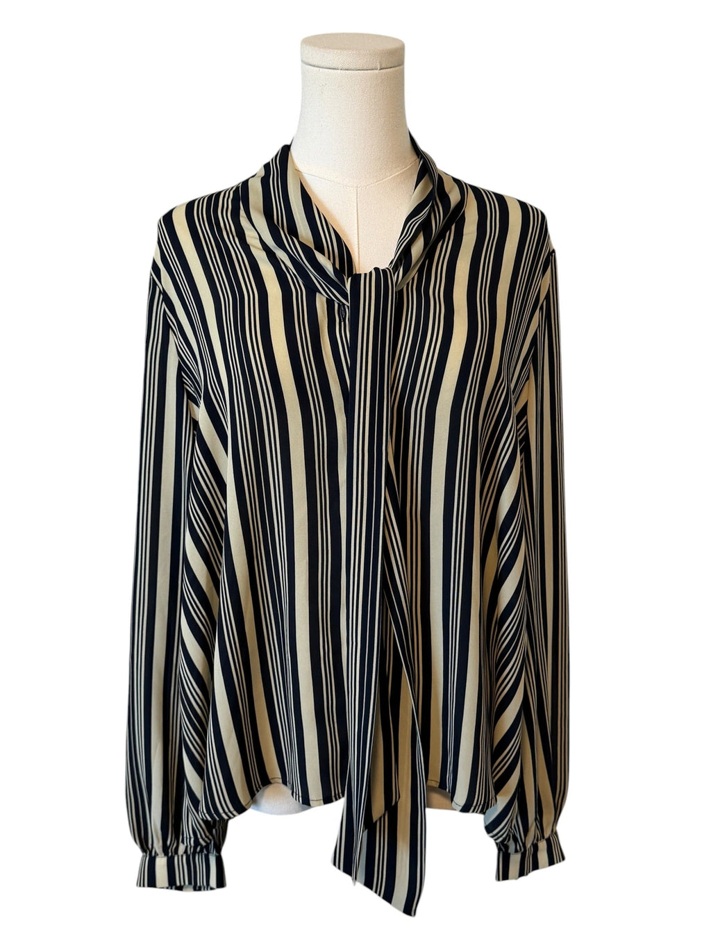 Striped blouse on a mannequin against a white background