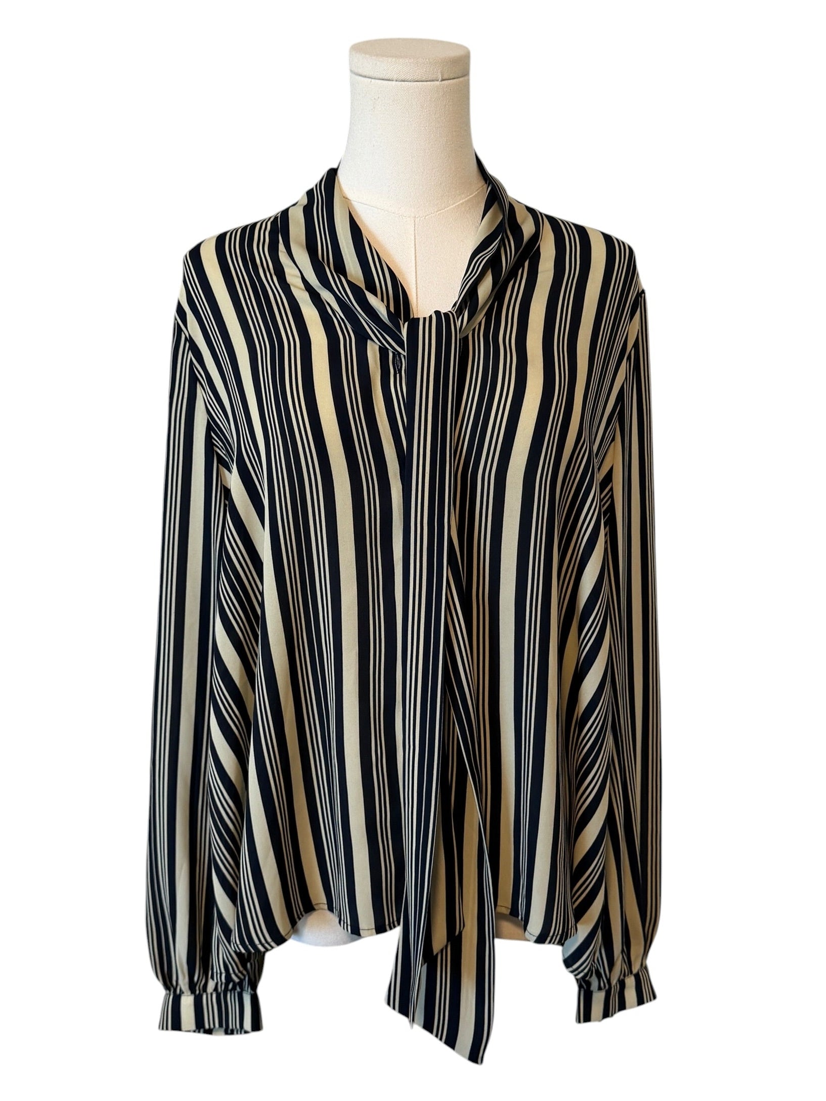 Striped blouse on a mannequin against a white background