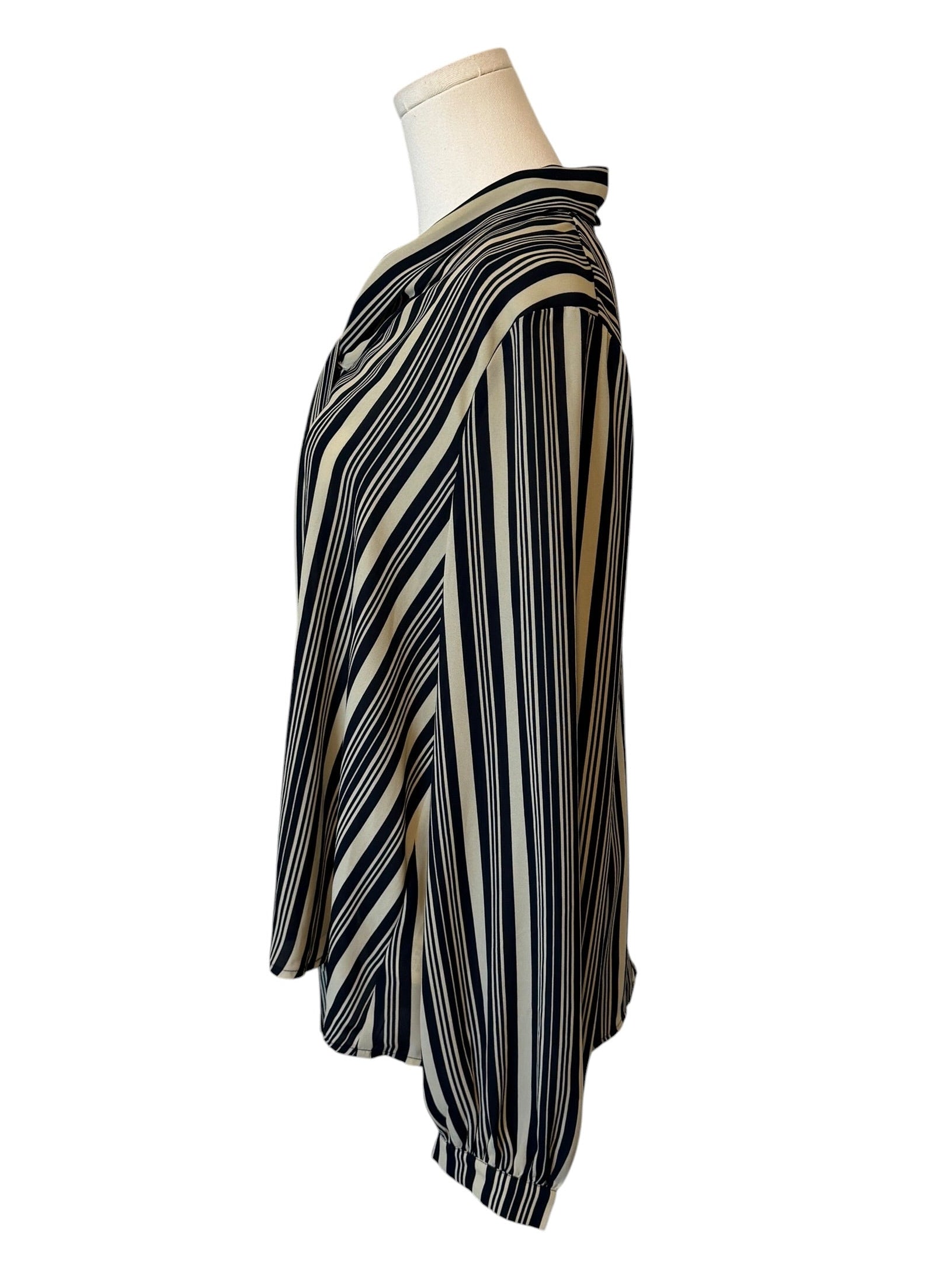 Striped dress on a mannequin against a white background