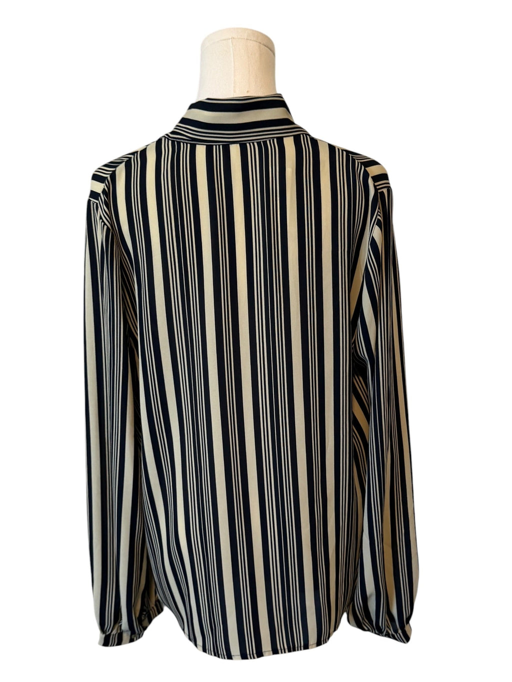 Striped shirt on a mannequin against a white background