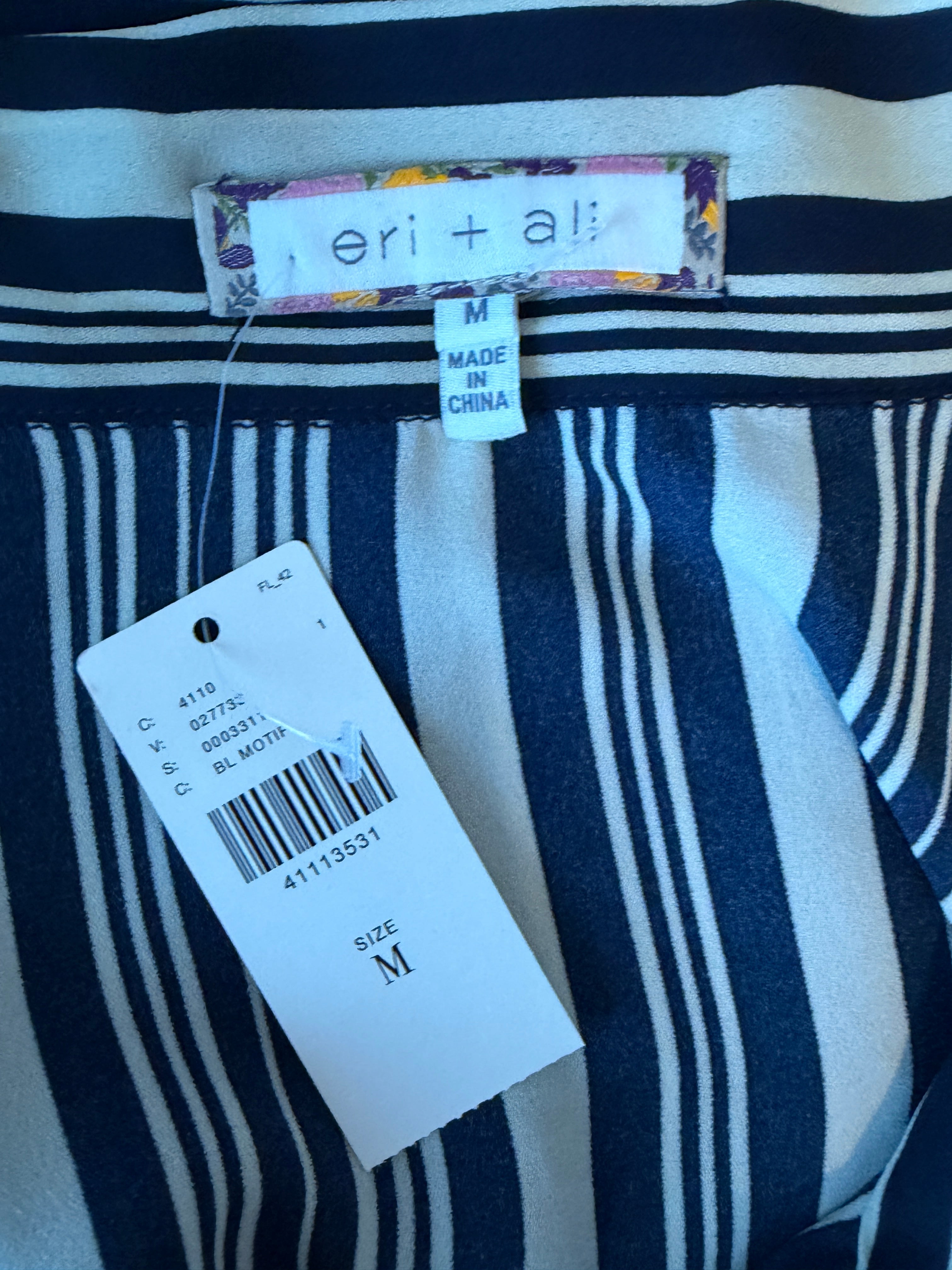 Navy and white striped shirt with a tag and size label on a blue background