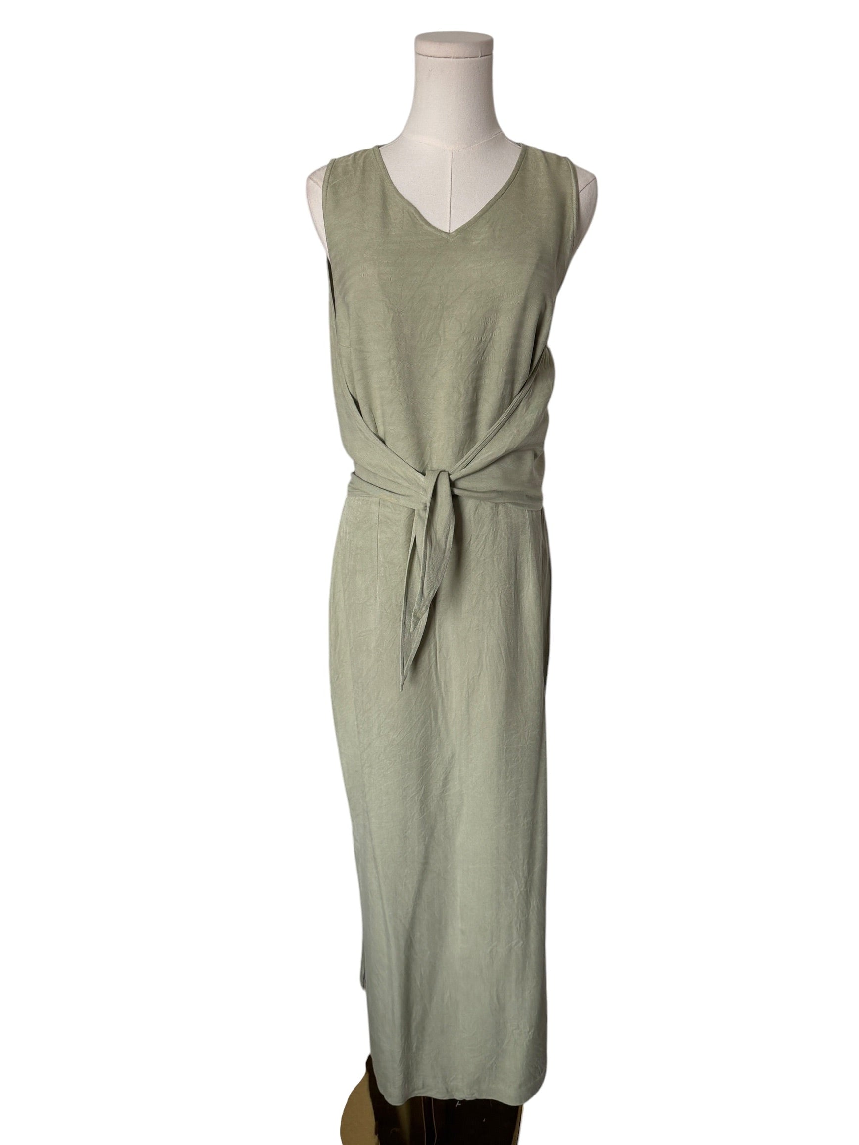 Green dress on a mannequin against a white background
