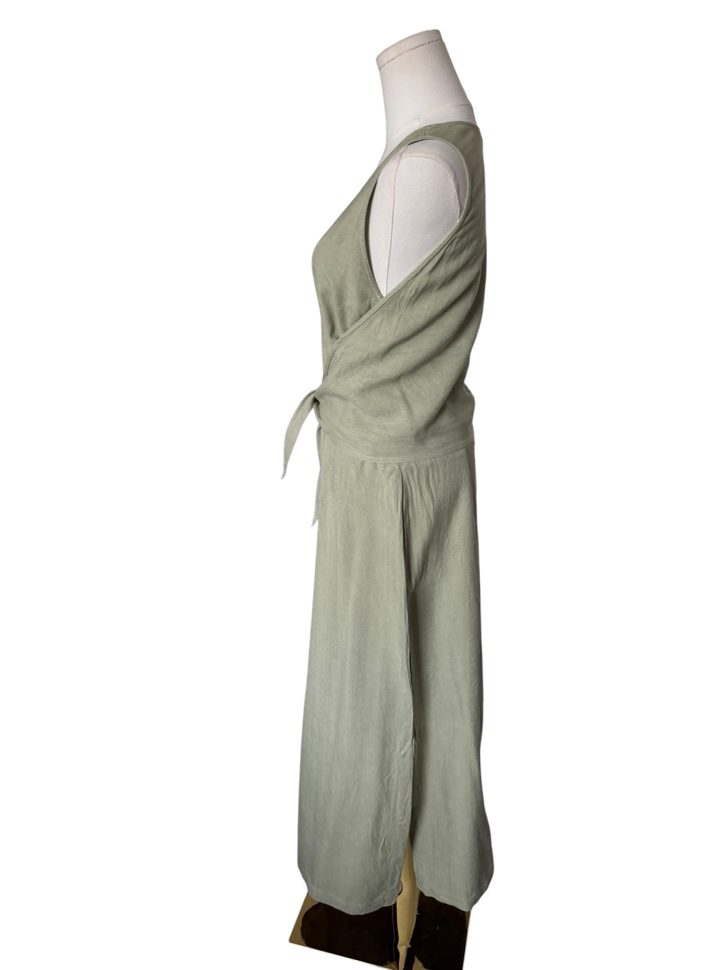 Green dress on a mannequin against a white background