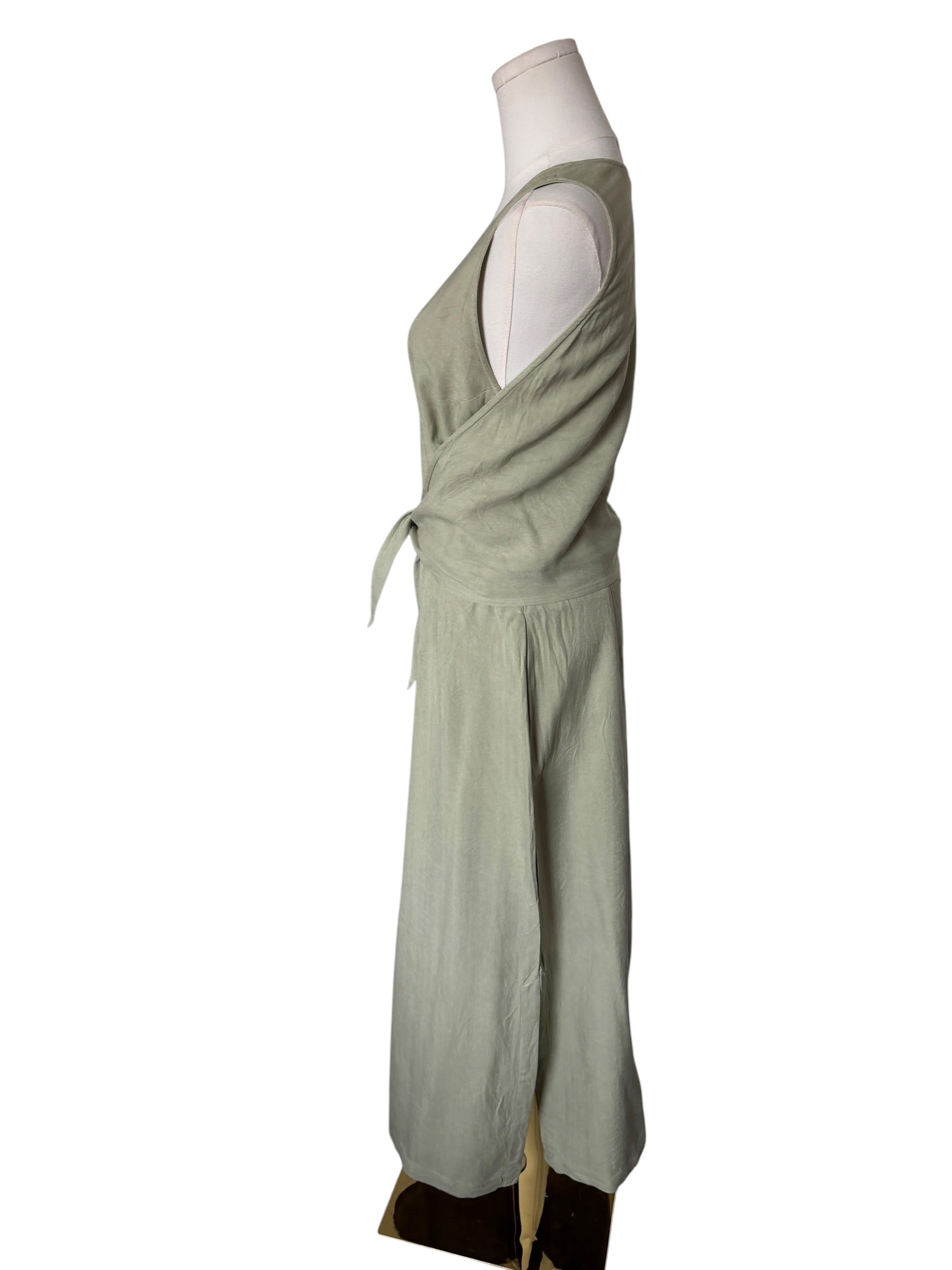 Green dress on a mannequin against a white background