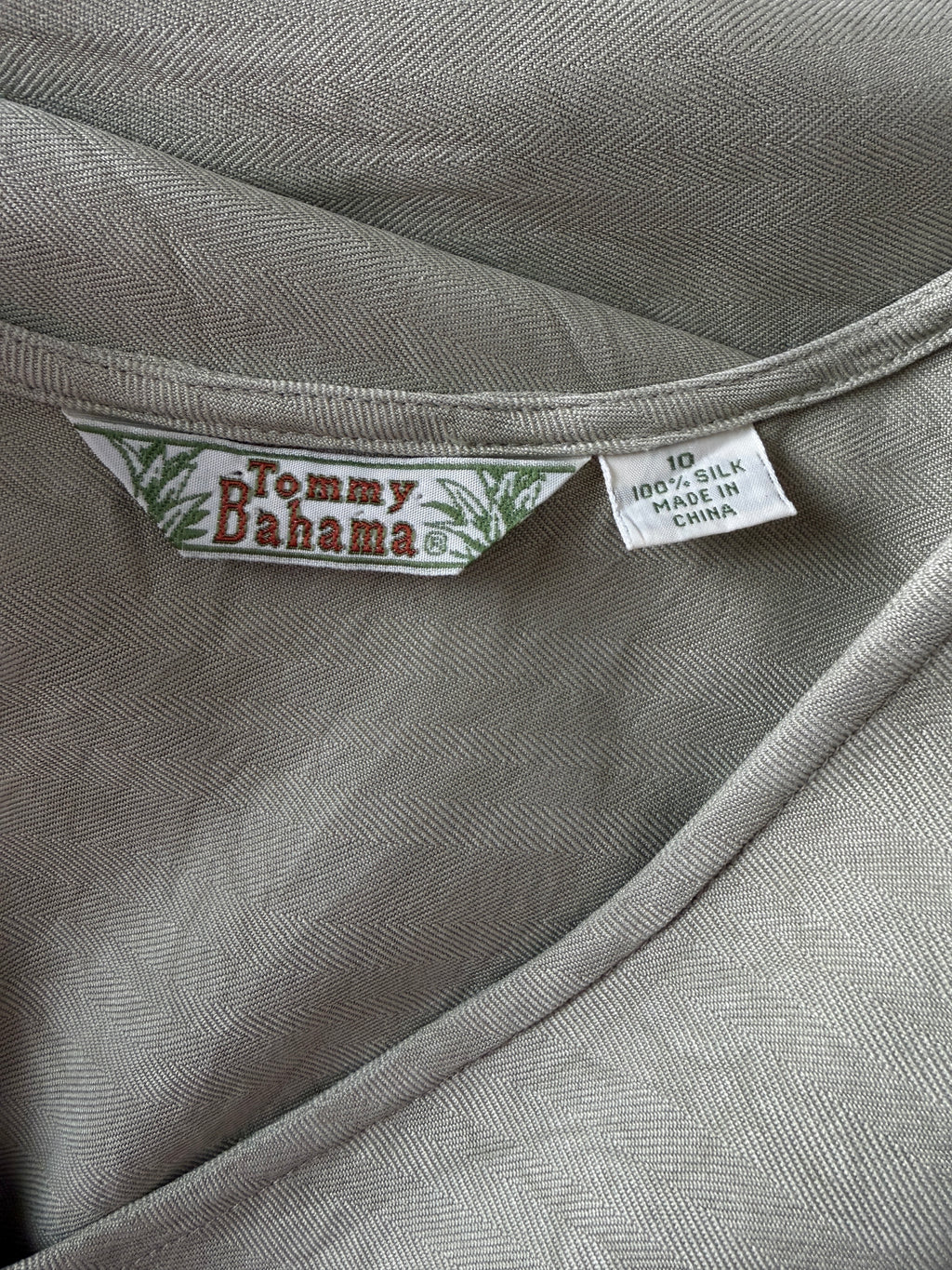 Tommy Bahama label on a gray fabric background