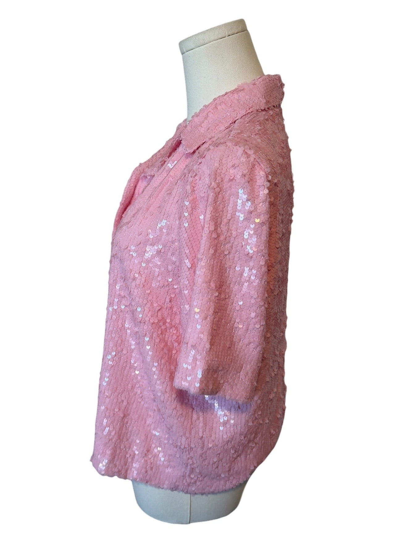 Pink sequin jacket on a mannequin against a white background