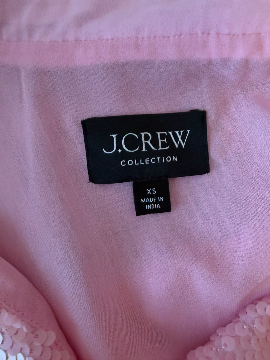 J.Crew label on a pink garment with lace details