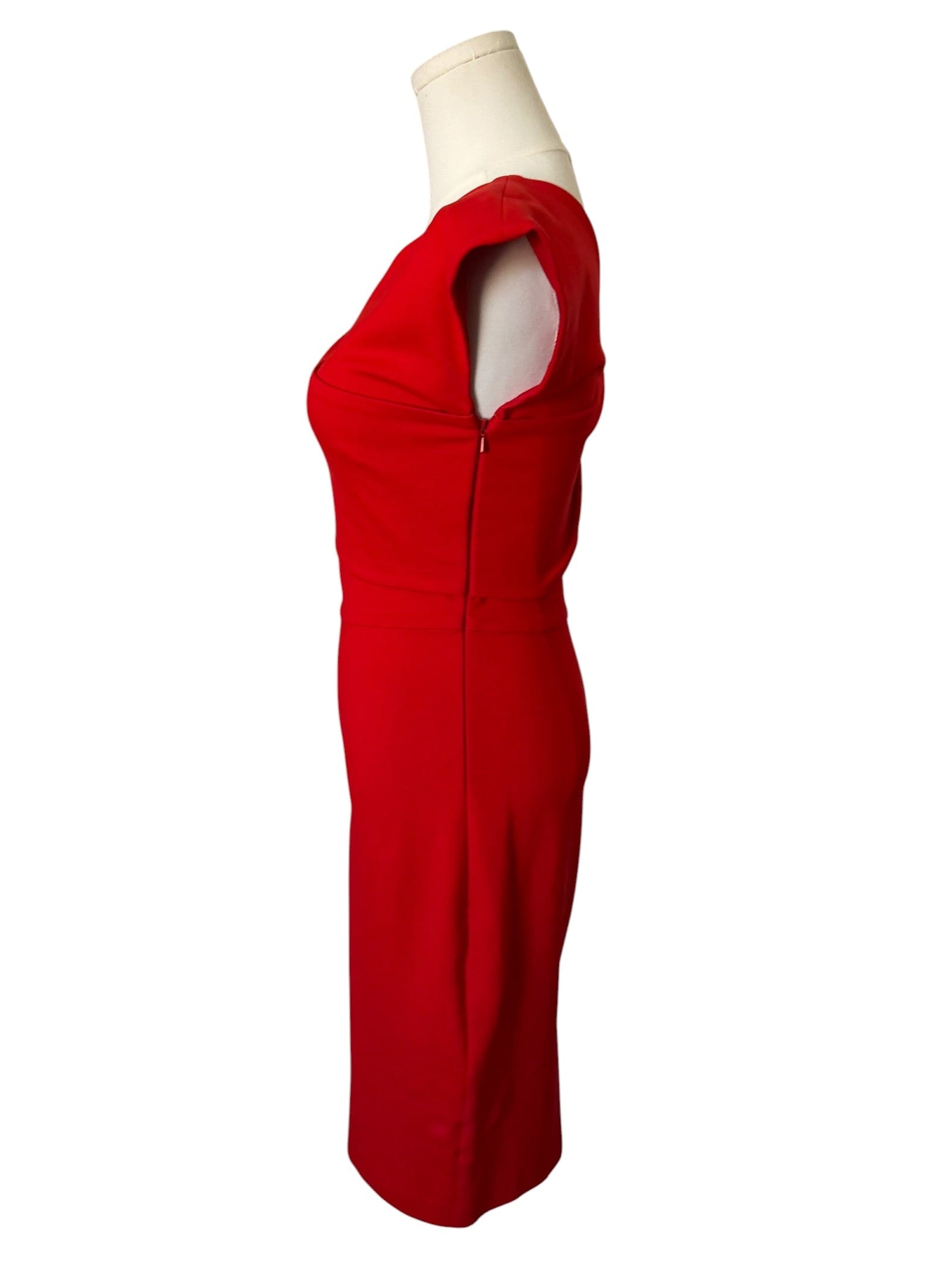 Red jumpsuit on a mannequin against a white background