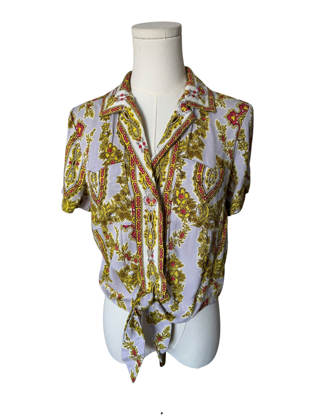 Sleeveless top with a colorful pattern on a mannequin against a white background